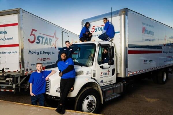 5 Star Moving crew standing with their moving truck in Colorado Springs - 5 Star Moving & Storage 5 Star Moving crew standing with their moving truck in Colorado Springs